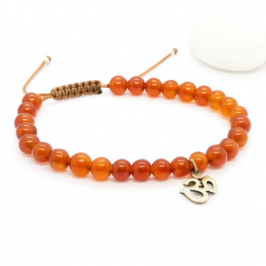 Orange beaded bracelet with a silver Om charm 